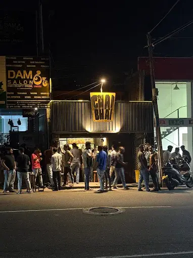 The Chai Bhai storefront in Peradeniya at night, busy with customers
